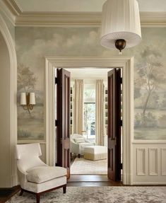 an elegant entry way with wallpaper and chairs