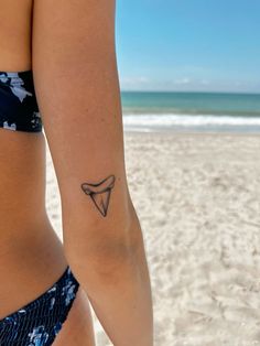 Sleeve Of Mini Tattoos, Women’s Shark Tattoo, Shark Tooth Tattoos For Women, Tattoo Ideas Female Shark, Small Shark Fin Tattoo, Dainty Shark Tooth Tattoo, Shark Tooth Tattoo Design, Octopus Hip Tattoos Women, Lifeguard Tattoo Ideas