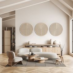 a modern living room with white furniture and wood accents on the walls, along with two circular artwork pieces