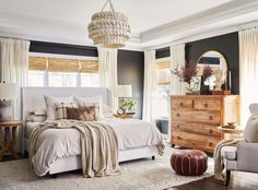 a bedroom with gray walls and white furniture