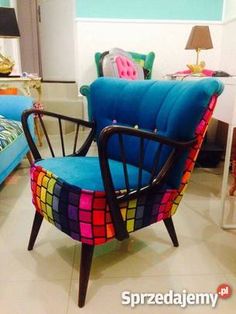 a living room filled with blue couches and colorful chairs