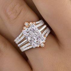 a woman's engagement ring with an oval cut diamond surrounded by three rows of diamonds