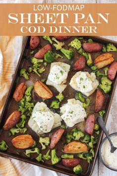 a sheet pan filled with potatoes, broccoli and other food on top of a table