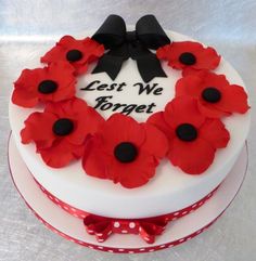 a white cake decorated with red and black flowers