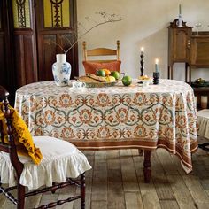 a dining room table with an orange and white cloth on it