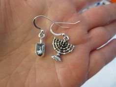 Hanukkah or Chanukah simple silver earrings Menorahs and Dreidels The 3 dimensional charms are sterling silver plated (nonlead) and made in USA. The ear wires are sterling silver --- choose between regular ear wires (soft ear nuts included) , posts (will have soft ear nuts and are 1/2" long, may be a flower or a ball) or sterling silver lever backs. Hypoallergic wires are available as well. Now we are offering hypoallergic leverbacks.All my earrings come with ear nuts. You will receive a brand n Sterling Silver Drop Earrings With Charms, Sterling Silver Dangle Earrings With Charms, Sterling Silver Charm Earrings As Gift, Sterling Silver Earrings With Charms For Gifts, Dainty Sterling Silver Charm Earrings, Minimalist Star Of David Sterling Silver Jewelry, Minimalist Sterling Silver Star Of David Jewelry, Sterling Silver Jewelry For Hanukkah Gifts, Minimalist Sterling Silver Charm Earrings