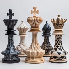 an assortment of chess pieces sitting on top of each other in front of a white background