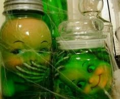 there are two jars that have green stuff in them and one has a face on it