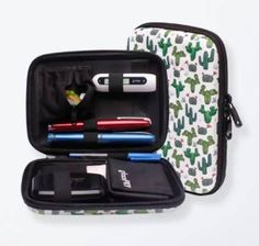 an open case with various items in it on a white surface, including pens and pencils