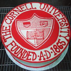 a cake that is decorated with the emblem of cornell university on it's side