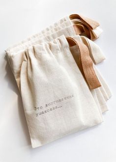 three bags with ties tied to them sitting on a white counter top next to each other