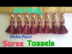 six tassels hanging from a curtain with the words, mattte pearl saree ta