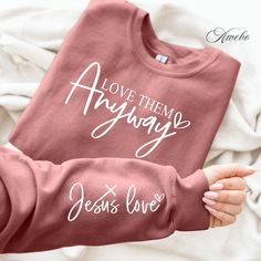 someone is holding up a shirt that says, love them always jesus's love