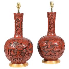 two red vases sitting next to each other