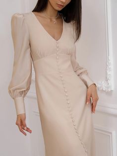 This sophisticated satin dress is embellished with tonal covered buttons. It039s designed with a gathering at the bodice and puffed sleeves finished with wide cuffs to channel a light romantic mood. The plunging neckline and the front slit delicately show a bit of skin.- midi-length hem- V-neckline- embellished with a row of covered buttons- front slit- concealed zip fastening along the side Embellished Midi Dress, Elegant Blouses, Online Fashion Store, Romantic Dress, Swimwear Shorts, Business Dresses, Everyday Dresses, Denim Jackets, Online Fashion Stores