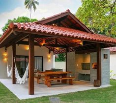 an outdoor covered patio with hammock chairs