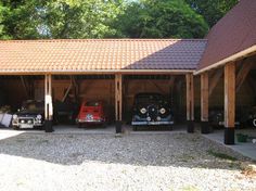 three cars are parked in the garage with their doors open