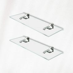 two glass shelfs with chrome handles on each side and one holding a towel bar