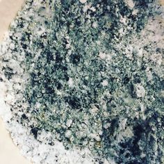 a close up of a pizza crust covered in toppings and seasoning powdered sugar