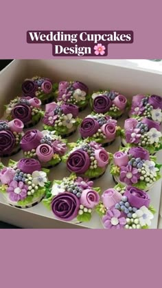 cupcakes decorated with purple and white flowers in a box