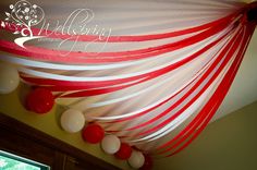 red and white streamers are hanging from the ceiling