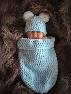 a newborn baby is wrapped in a blue blanket