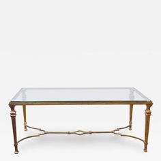 a coffee table with glass top and gold metal frame, in the style of louis ii