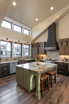 a large kitchen with an island in the middle