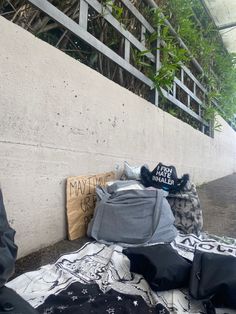 several bags sitting on the ground next to a wall