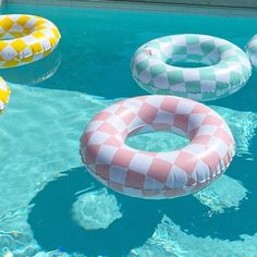 inflatable floats floating on top of a swimming pool