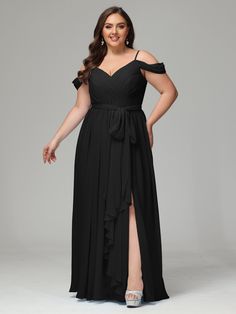 a woman in a long black dress posing for the camera