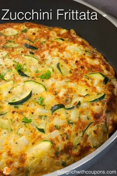 an omelet with zucchini and cheese in a pan on a table