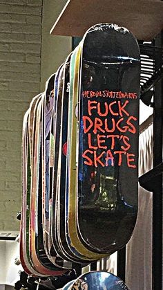 a bunch of skateboards that are hanging up