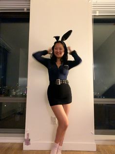 a woman in bunny ears is posing for the camera