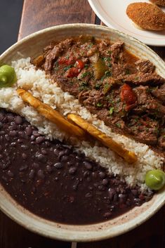 a bowl filled with rice, beans and meat