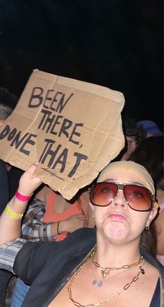 a woman holding up a sign that says, been there done that in front of her