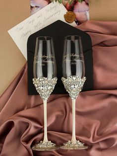 two champagne flutes with personalized names on them