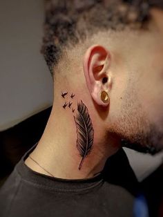 a man with a tattoo on his neck has a feather and birds flying around him