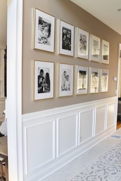 a living room with pictures on the wall