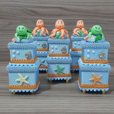 there are four little sea creatures sitting on top of each other in this toy box