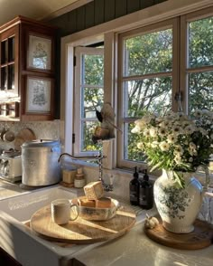 a kitchen counter with pots and pans on top of it next to a window