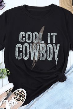 Black Cool It Cowboy Short Sleeve Graphic Tee Edgy Black Slogan Top, Black Edgy Slogan Top, Cool Black Crew Neck Top, Cool Black Top With Crew Neck, Casual Black Slogan Shirt, Cool Black Top With Graphic Print, Black Slogan Shirt For Spring, Cool Black Tops With Letter Print, Cool Black Summer Top