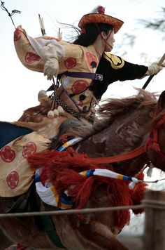 a man riding on the back of a brown horse