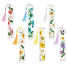 four different colored flower bookmarks with tassels