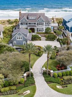 this is an aerial view of a house on the beach with its driveway and landscaping