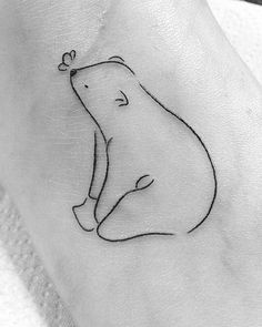 a small bear tattoo on the ankle