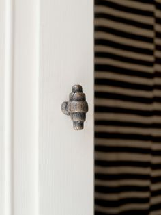 a close up of a door handle on a white door