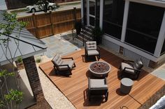 an aerial view of a patio with chairs and fire pit