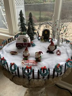 a snow covered cake with christmas decorations on it