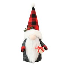 a red and black gnome ornament hanging on a white wall